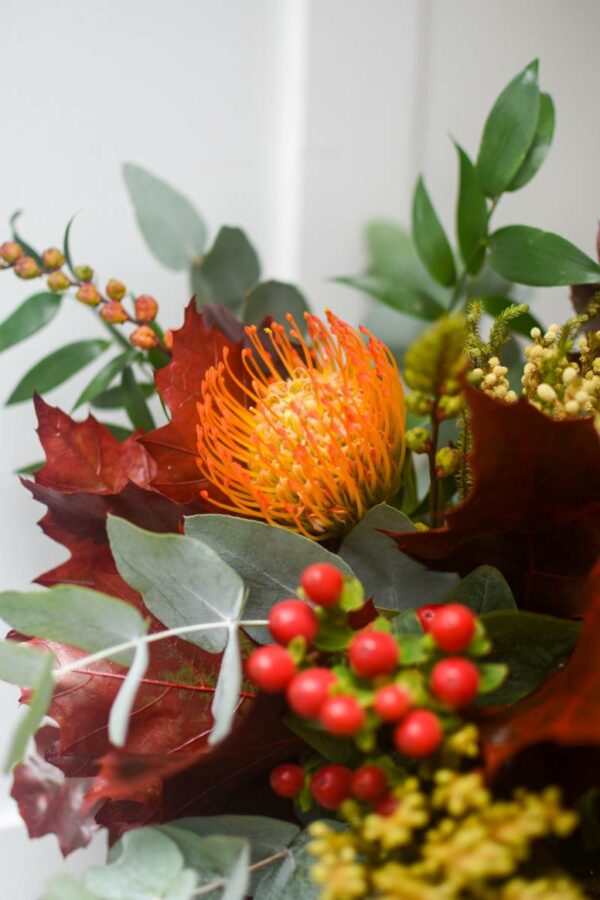Seasonal autumn bouquet decorated with oak leaves and eucalyptus