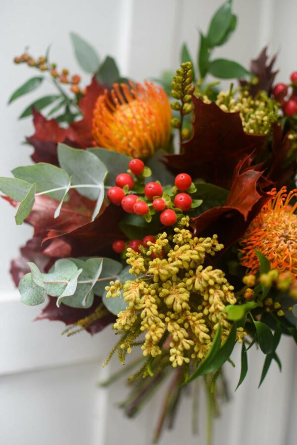 Bright seasonal bouquet in autumn colors toned in yellow, orange and dark red