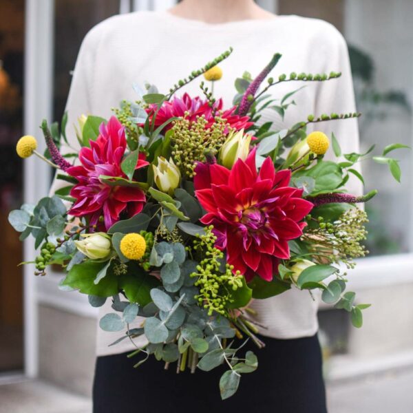 large bouquet of seasonal flowers in autumn colors with large red dahlias